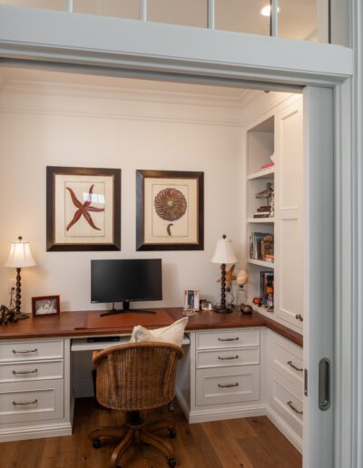 A home office with a desk and a chair.