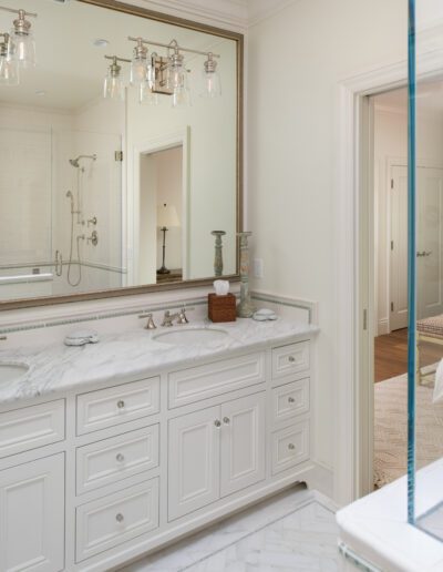 A bathroom with a large mirror and two sinks.