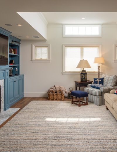 A living room with blue cabinets and a fireplace.